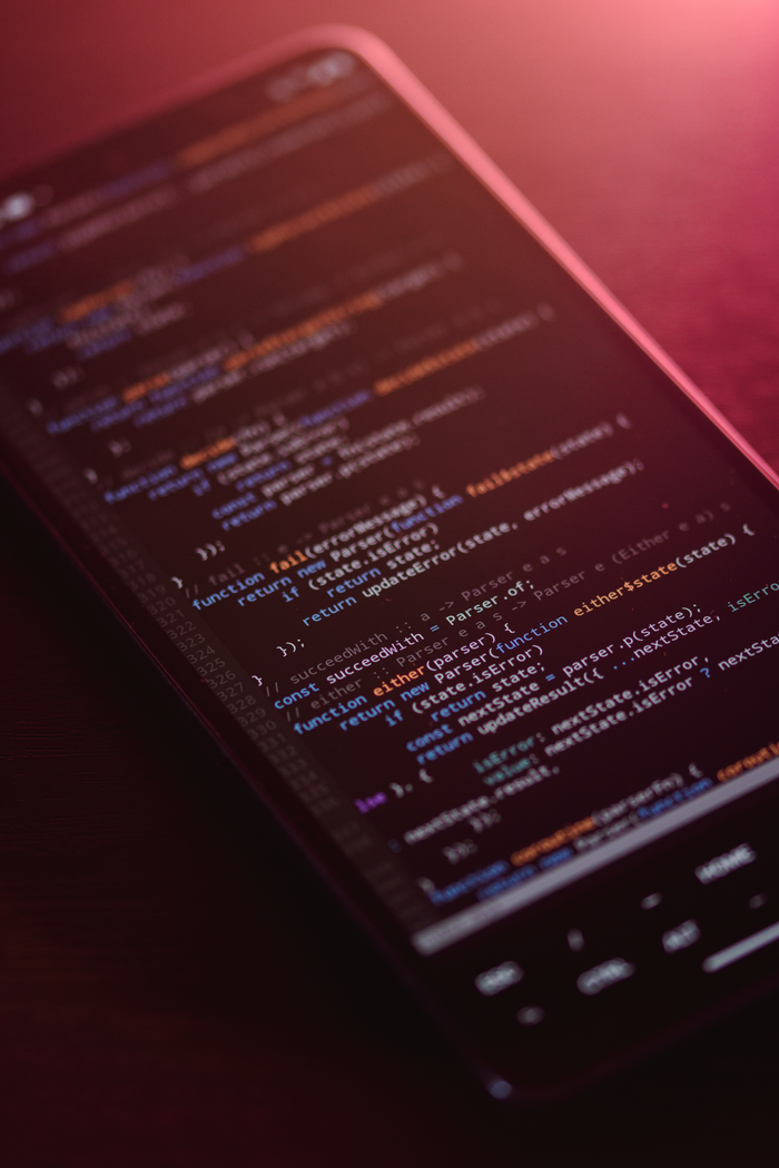 Colorful code displayed on a smartphone screen with a warm glow.